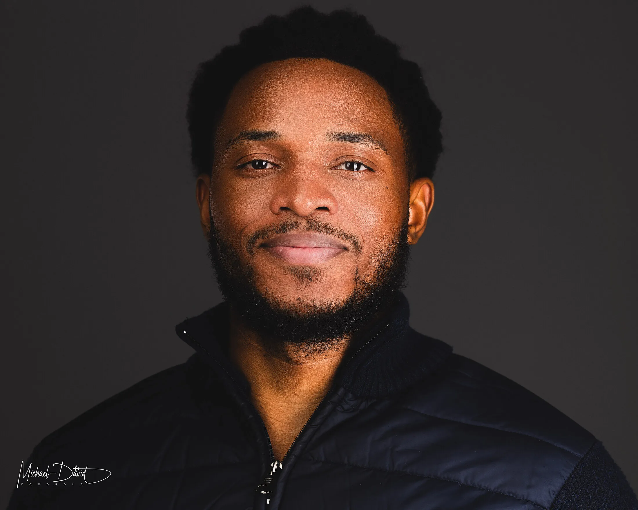 Studio headshot, low-key lighting